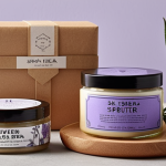 **

A beautifully arranged gift set of organic cosmetics. Focus on natural ingredients like lavender sprigs, shea butter, and aloe vera leaves. The packaging should be eco-friendly: recycled paper, glass jars, and minimal plastic. The overall aesthetic should evoke a sense of relaxation and well-being, like a home spa experience. Soft, diffused lighting.

**